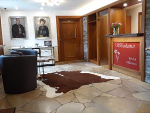 a lobby with a damaged floor in a building at Gästehaus Walserheimat in Riezlern