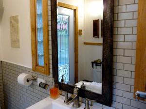 a bathroom with a sink with a mirror and a window at Magnolia Petal in Ganges