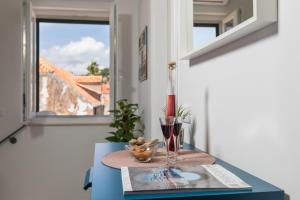洛普德島的住宿－Skipper's Suite，一张桌子,上面放着葡萄酒杯和花瓶