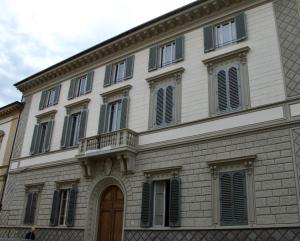 a large white building with a balcony on it at M&G Apartment in Florence