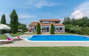 a villa with a swimming pool and a house at Villa Rosa in Nova Vas
