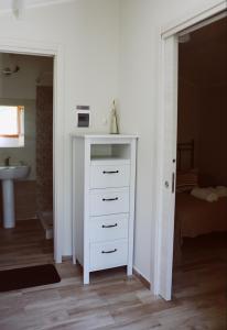 a white dresser in a room with a bedroom at Agriturismo San Leonardo in Centola