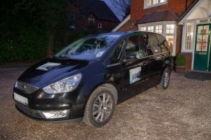 a small blue car parked in front of a house at Gatwick Turret Guest House in Horley