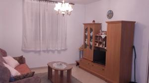 a living room with a couch and a cabinet and a table at House Paradise in Širitovci
