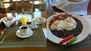 a plate of food with eggs and beans on a table at Hotel Casa San Pancho in San Francisco