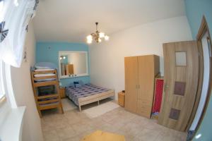 a small room with a bed and a mirror at Studio-tani apartament in Rowy