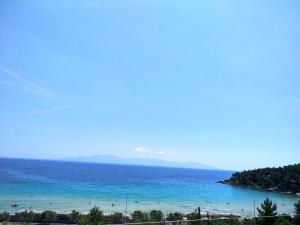 a view of the ocean with a beach in the foreground at Blue4Aqua Apartments in Kavála