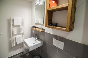a bathroom with a sink and a mirror at Staycity Aparthotels Dresden City Centre in Dresden +25 photos