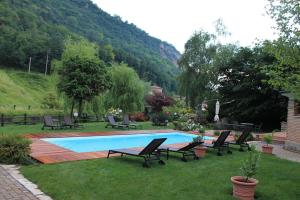 a pool with chaise lounge chairs at Hotel Calvi-Ristorante Mainor in Vittorio Veneto