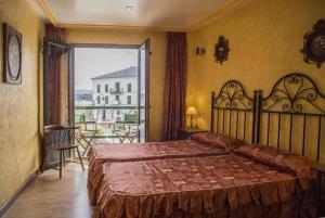 Postel nebo postele na pokoji v ubytování Hotel A. G. Porcillan