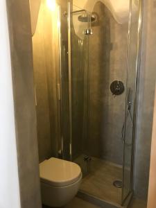 a bathroom with a toilet and a glass shower at CASA FLAMI' in Ostuni