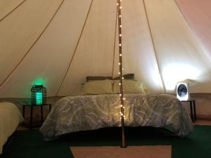 a bedroom with a bed in a tent at Glampin' In Style-Broken Bow in Broken Bow