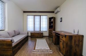 a living room with a couch and a desk at Apartment Balchik in Balchik