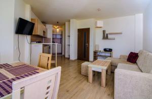 a living room with a couch and a table at Apartment Balchik in Balchik