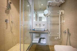 a bathroom with a sink and a shower at Hotel Le Lampare in Caorle +52 photos