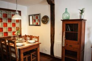 a dining room with a wooden table and chairs at Apartamento El 31 de Bilbao in Bilbao