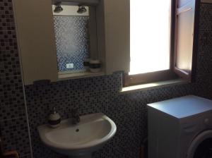 a bathroom with a sink and a mirror and a toilet at villa Vanelle in Isola delle Femmine