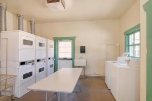 a kitchen with white appliances and a table at Palm Canyon Hotel and RV Resort in Borrego Springs