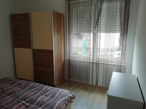 a bedroom with a bed and a large window at Apartment Greta,50 METERS TO THE BEACH in Banjole