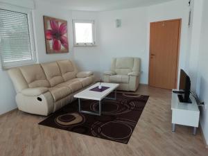 a living room with a couch and a table at Apartment Greta,50 METERS TO THE BEACH in Banjole
