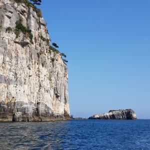 a cliff in the ocean next to the water at a casa di nonna Elza in La Spezia