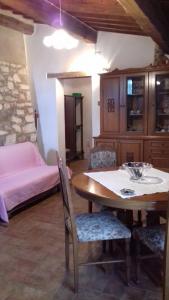 a dining room with a table and a bed at Agriturismo San Pietro in Castiglione dʼOrcia