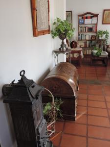 a living room with an old chest on a tile floor at Hosteria Las Piedras in Puerto Madryn