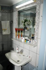 a bathroom with a sink and a mirror at Giorgos-Vera in Kavála +37 photos