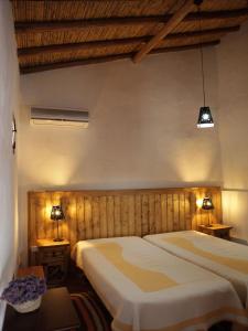 a bedroom with a large bed and two lamps at Casas do Palheiro Velho in Castro Marim +34 photos