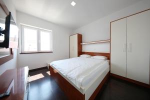 Posteľ alebo postele v izbe v ubytovaní Apartmani Postimana