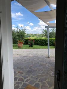 an open door to a patio with a view at Oliveta in Tavarnelle Val di Pesa