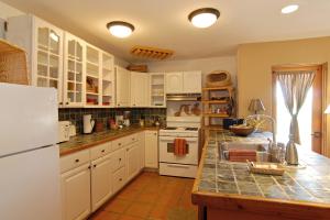 a kitchen with white cabinets and a counter top at Borrego Valley Inn in Borrego Springs