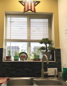 a kitchen sink with a window with a star above it at Hollywood Stay in Los Angeles