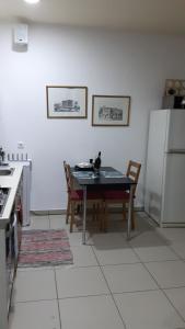 a kitchen with a table and chairs and a refrigerator at Hermes Gerakas-Athens in Athens