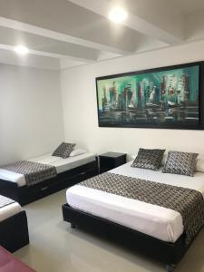 Ένα ή περισσότερα κρεβάτια σε δωμάτιο στο Apartamentos Cartagena Caribe Suite