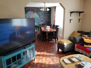 a living room with a large flat screen tv at Hamtramck Hostel in Detroit