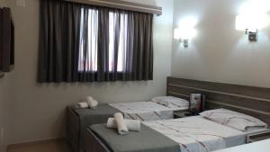 Krevet ili kreveti u jedinici u okviru objekta Brasilia Parque Hotel
