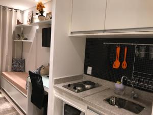 a small kitchen with a sink and a stove at Studio Augusta in Sao Paulo +8 photos