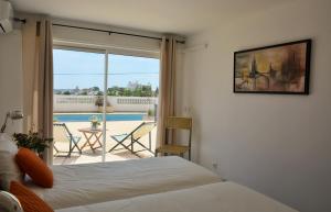 a bedroom with a bed and a view of a pool at Tavira Terrace in Tavira