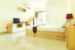 a bedroom with a bed and a television in it at Be My Guest 36 in Bangkok +33 photos