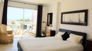 a bedroom with a bed with a view of a patio at Tavira Terrace in Tavira
