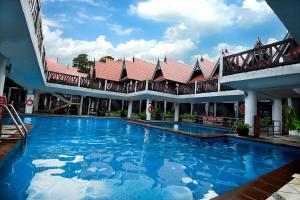 a hotel room with a pool and a swimming pool at Paya Beach Spa & Dive Resort in Tioman Island