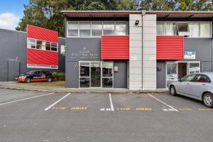 a car parked in a parking lot in front of a building at Cozy one bedroom apartment near Auckland Airport in Auckland