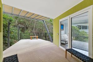an empty balcony with a table and bench on it at Pier 26 Coastal Retreat in Copacabana +2 photos