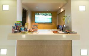 a lobby with a counter with books on it at Cairns City Apartments in Cairns