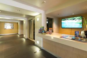 a lobby with a display case with a flat screen tv at Cairns City Apartments in Cairns