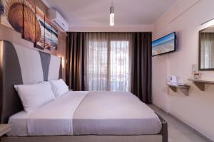 a hotel room with a bed and a window at House Katerina Mediterranean in Sarti