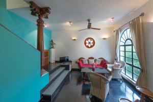 a living room with a couch and a table at Malabar House in Cochin