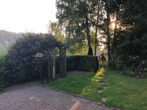 a garden with a gate in the grass at Pension Raststüb'l in Sorge