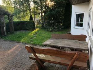 a wooden bench sitting outside of a house at Pension Raststüb'l in Sorge